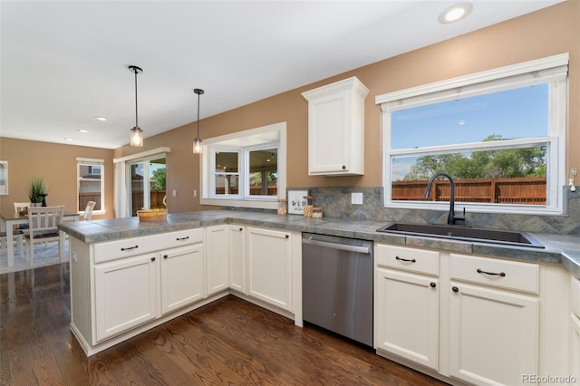 12814 Forest Cir, Thornton, CO 80241 - kitchen featuring stainless steel dishwasher, a sink, a peninsula, dark wood finished floors, and white cabinets