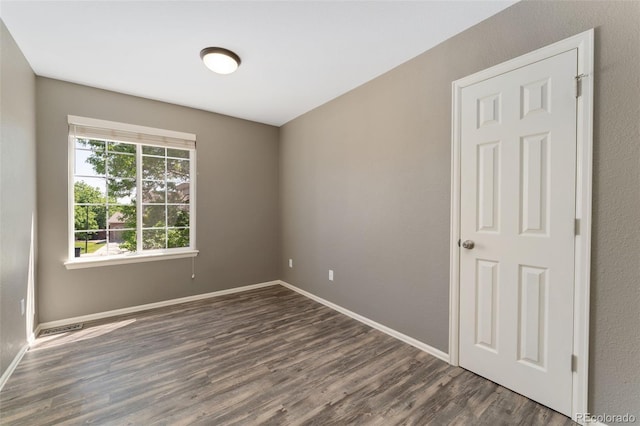 12814 Forest Cir, Thornton, CO 80241 - spare room with dark wood-type flooring and baseboards