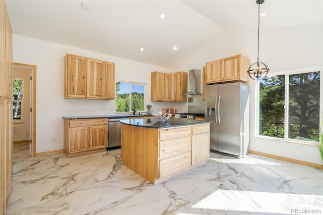 kitchen with a notable chandelier, vaulted ceiling, hanging light fixtures, wall chimney range hood, and appliances with stainless steel finishes