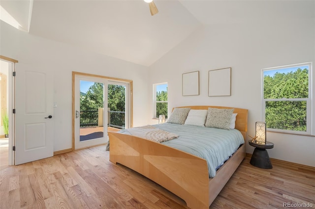 bedroom featuring access to outside, light hardwood / wood-style floors, ceiling fan, and high vaulted ceiling