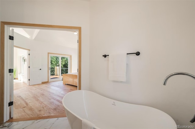 bathroom with hardwood / wood-style floors and a bathtub