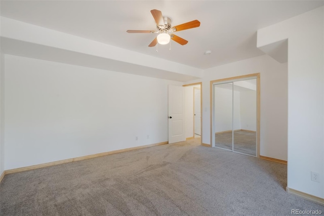 unfurnished bedroom with ceiling fan, light colored carpet, and a closet