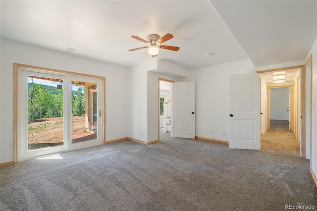 spare room featuring ceiling fan and carpet flooring