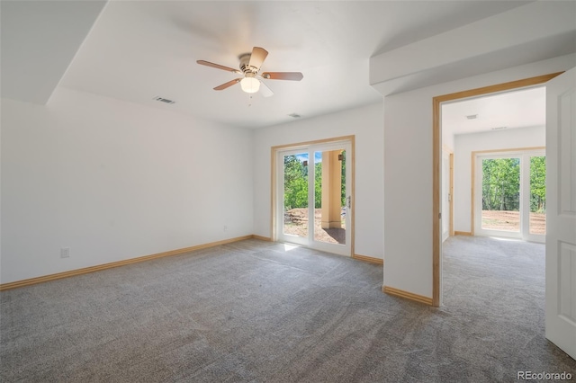 unfurnished room featuring ceiling fan and carpet floors