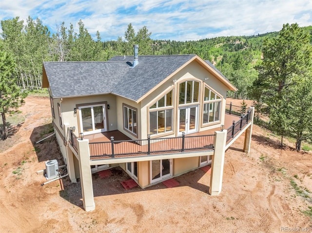 back of property featuring a wooden deck and central air condition unit