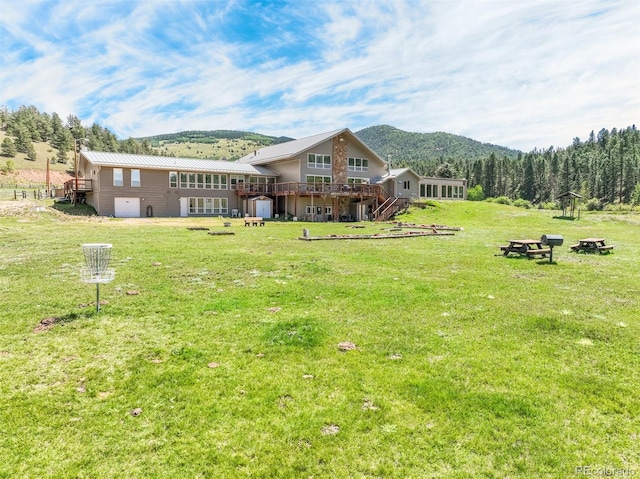 view of yard featuring a deck with mountain view