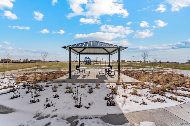 snow covered patio featuring a rural view and a gazebo