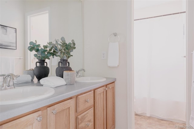 full bathroom featuring a sink, a shower with curtain, and double vanity