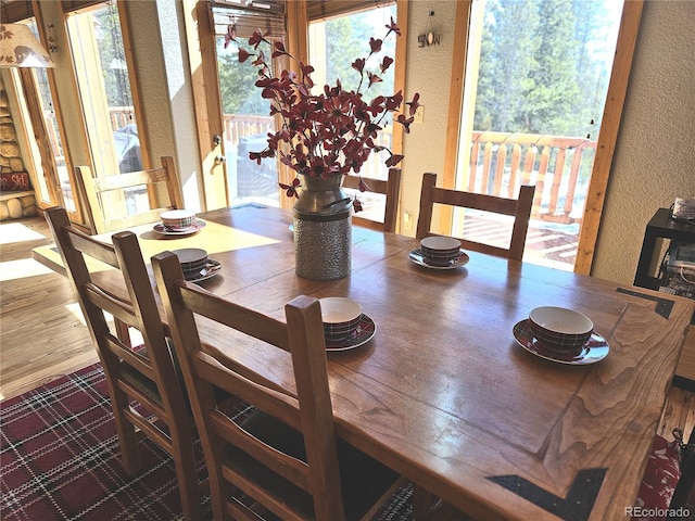 dining room with wood finished floors and a textured wall