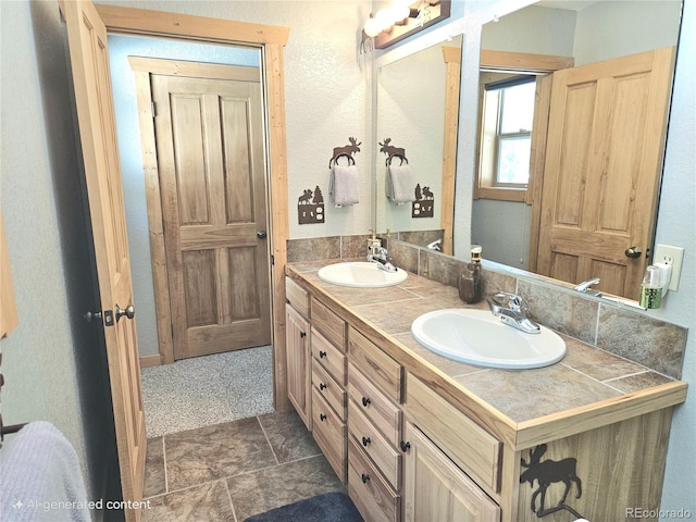 full bath featuring double vanity and a sink