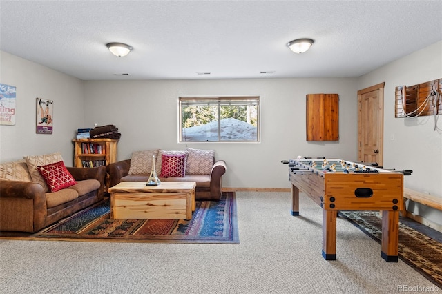 playroom with a textured ceiling, carpet floors, and baseboards