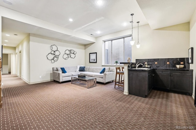 living room with baseboards, dark colored carpet, and recessed lighting