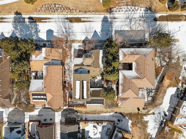 snowy aerial view with a residential view