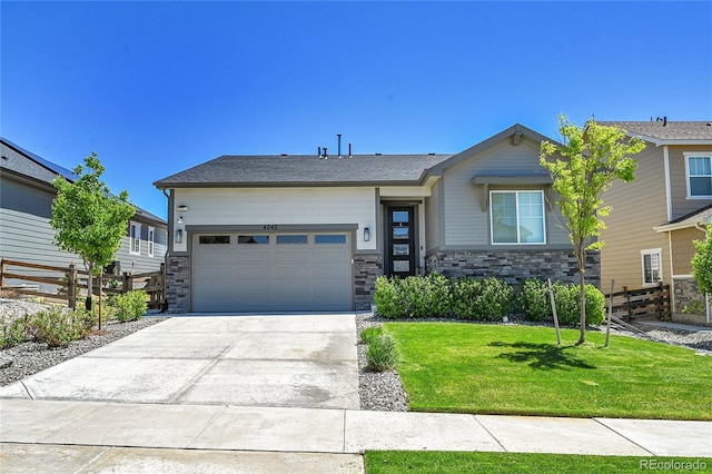 4040 Eaton Park St, Aurora, CO 80019 - view of front of property with a garage, concrete driveway, and stone siding