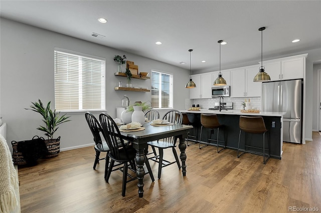 4040 Eaton Park St, Aurora, CO 80019 - dining area featuring recessed lighting, wood finished floors, and baseboards