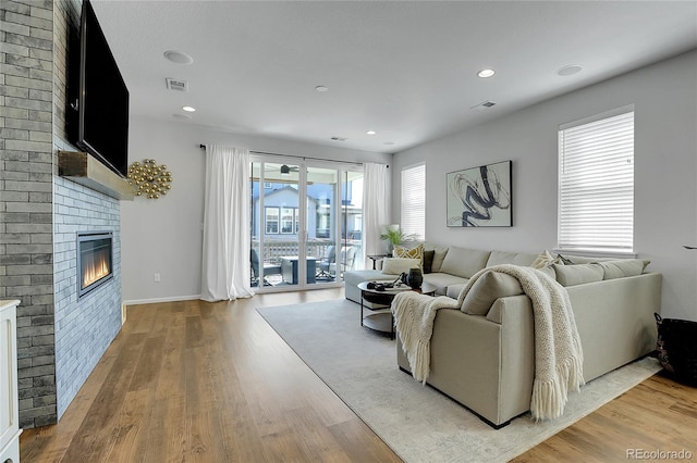 4040 Eaton Park St, Aurora, CO 80019 - living area featuring a fireplace, light wood-style floors, recessed lighting, and baseboards