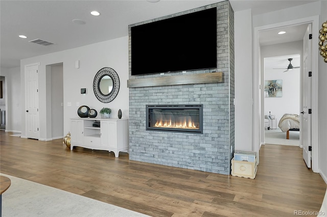 4040 Eaton Park St, Aurora, CO 80019 - living area featuring wood finished floors, a ceiling fan, a fireplace, recessed lighting, and baseboards