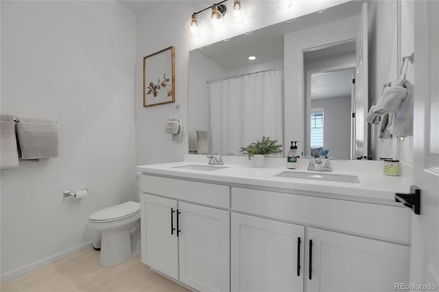 4040 Eaton Park St, Aurora, CO 80019 - full bath featuring double vanity, toilet, and baseboards
