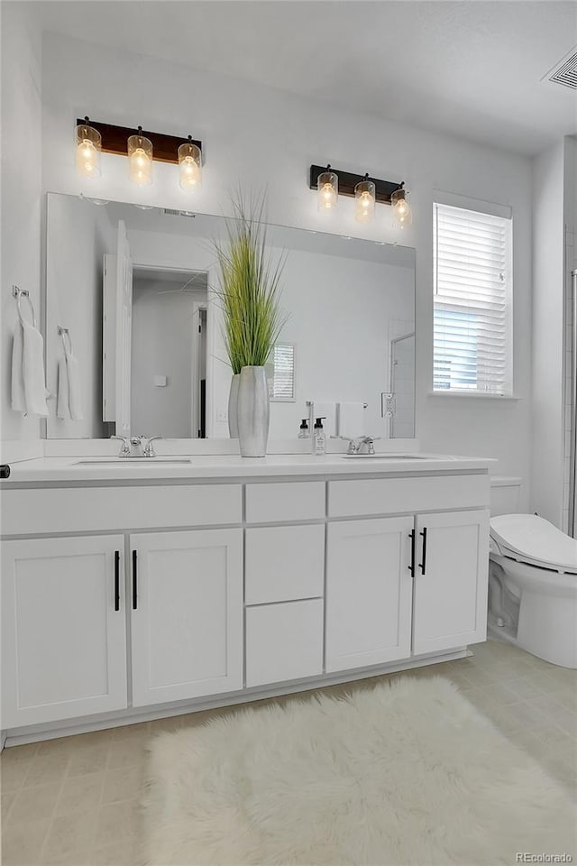 4040 Eaton Park St, Aurora, CO 80019 - bathroom with double vanity, toilet, and a shower