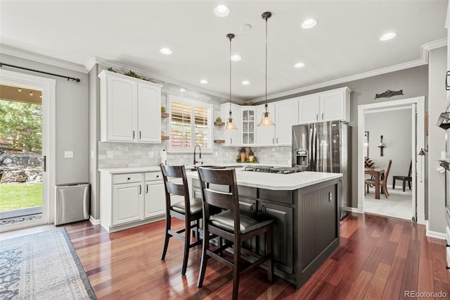 3188 Lynwood Ave, Highlands Ranch, CO 80126 - kitchen with crown molding, light countertops, white cabinetry, stainless steel appliances, and dark wood-style floors