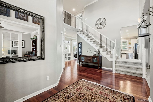 3188 Lynwood Ave, Highlands Ranch, CO 80126 - entryway with a towering ceiling, wood finished floors, stairway, baseboards, and recessed lighting