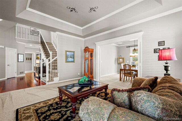 3188 Lynwood Ave, Highlands Ranch, CO 80126 - living area featuring wood-type flooring, an inviting chandelier, baseboards, stairway, and a raised ceiling