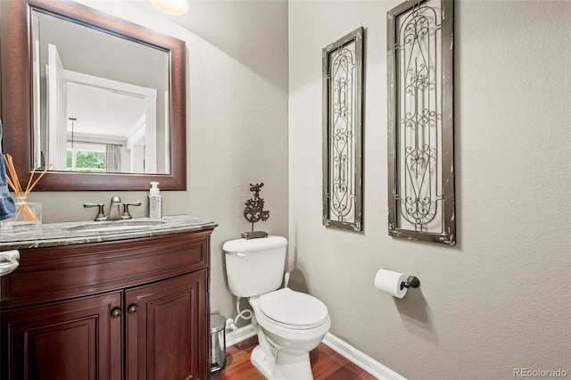 3188 Lynwood Ave, Highlands Ranch, CO 80126 - half bathroom featuring vanity, baseboards, toilet, and wood finished floors
