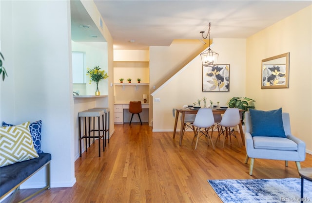 living area featuring a notable chandelier and hardwood / wood-style floors