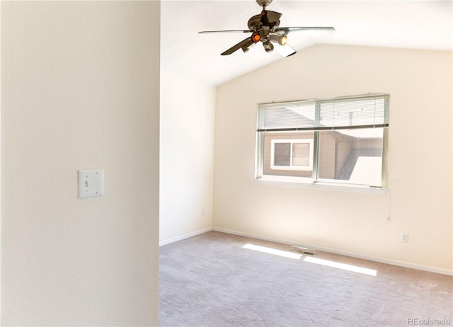 carpeted empty room with ceiling fan and lofted ceiling