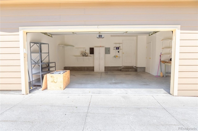 garage with a garage door opener and electric panel