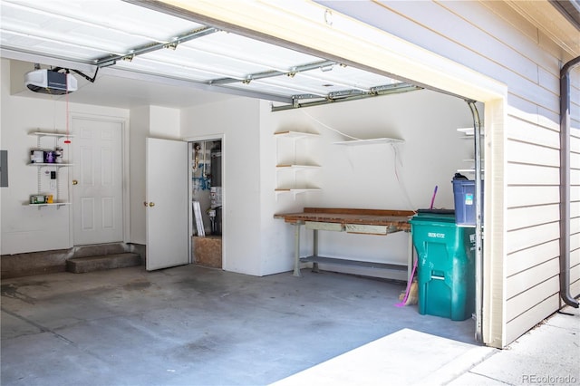 garage with a garage door opener and electric panel