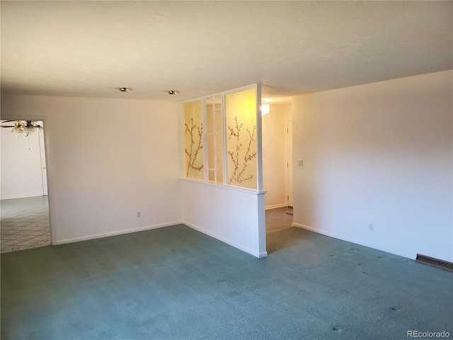 carpeted spare room with ceiling fan