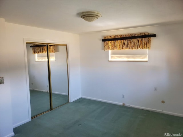 unfurnished bedroom featuring a closet and dark colored carpet