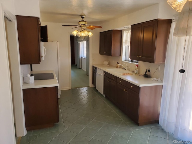 kitchen featuring light tile patterned flooring, sink, white appliances, dark brown cabinets, and ceiling fan