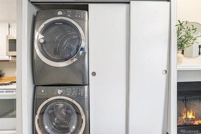 washroom featuring stacked washer / drying machine