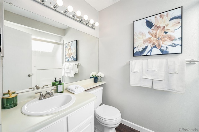 bathroom featuring hardwood / wood-style floors, vanity, and toilet