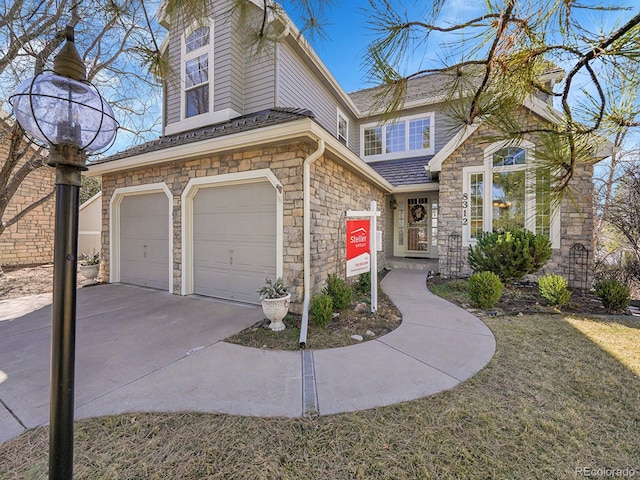 8312 S Peninsula Dr, Littleton, CO 80120 - view of front of house with stone siding, an attached garage, and concrete driveway