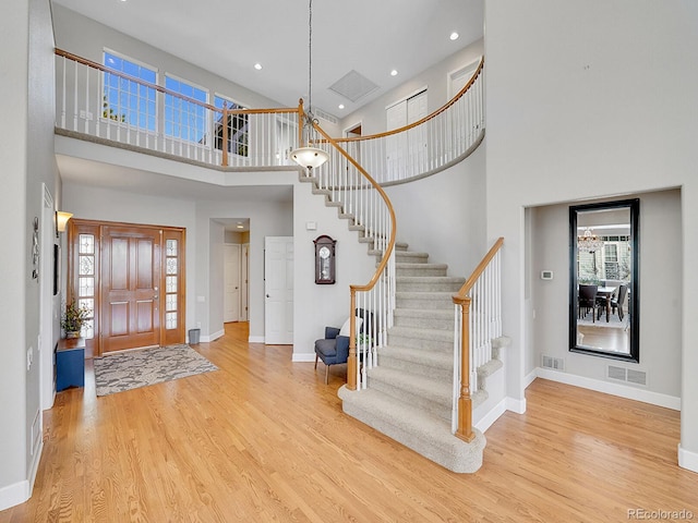 8312 S Peninsula Dr, Littleton, CO 80120 - foyer with a towering ceiling, wood finished floors, baseboards, stairway, and recessed lighting