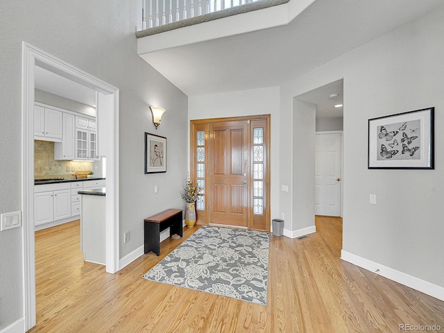 8312 S Peninsula Dr, Littleton, CO 80120 - foyer with light wood-style flooring and baseboards