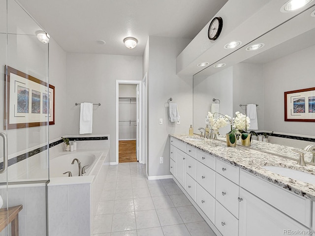 8312 S Peninsula Dr, Littleton, CO 80120 - bathroom featuring a bath, double vanity, tile patterned flooring, a walk in closet, and a stall shower
