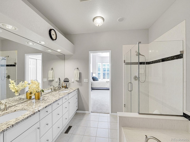 8312 S Peninsula Dr, Littleton, CO 80120 - ensuite bathroom with a stall shower, double vanity, tile patterned floors, baseboards, and a textured ceiling