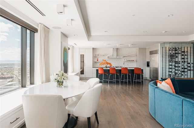 dining space with plenty of natural light and hardwood / wood-style flooring