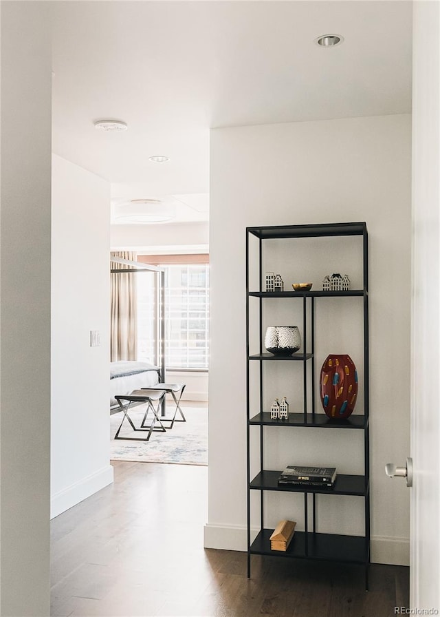 hallway with hardwood / wood-style floors