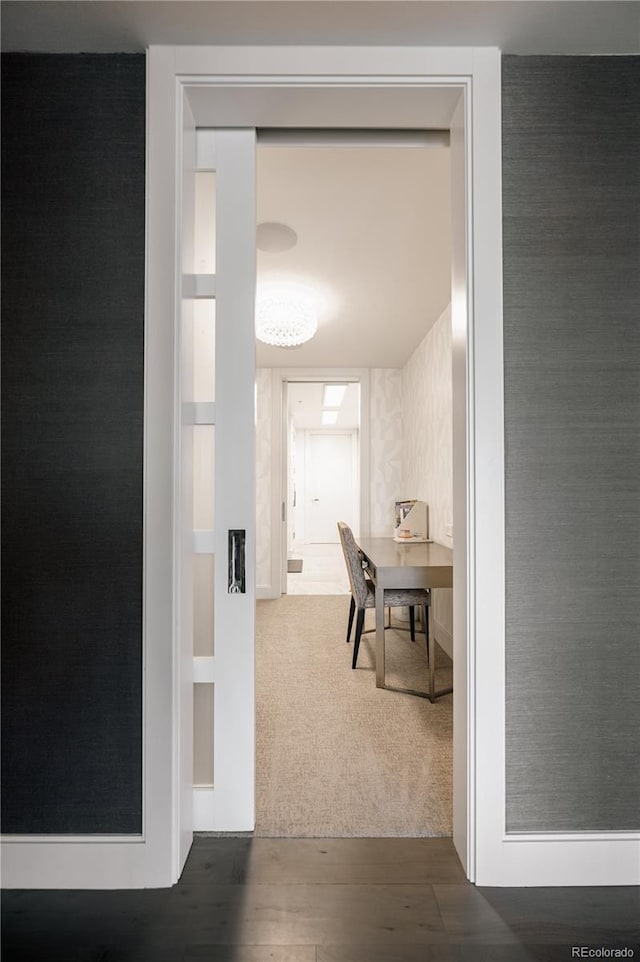 hallway featuring dark wood-type flooring and built in shelves