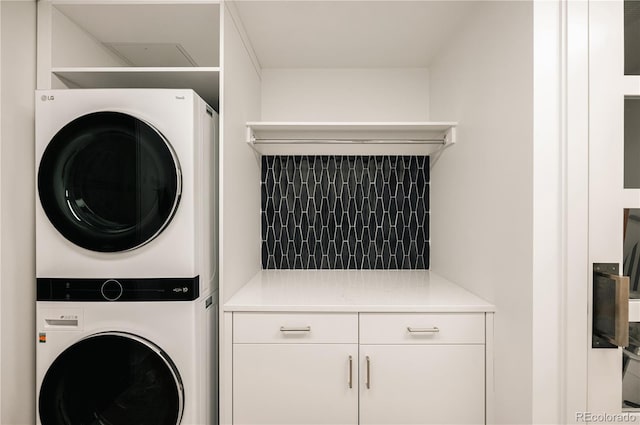 laundry area featuring stacked washer / dryer