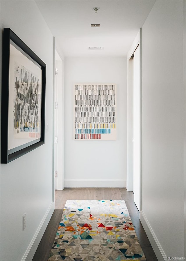 corridor featuring wood-type flooring