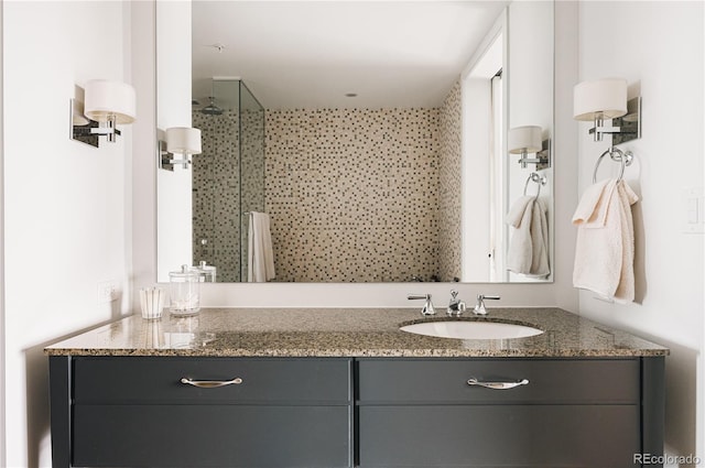 bathroom with walk in shower and vanity