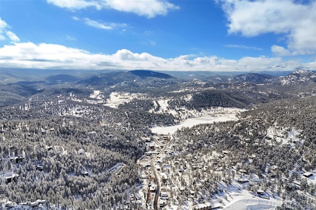 snowy aerial view featuring a mountain view