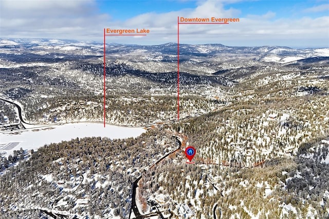 snowy aerial view featuring a mountain view