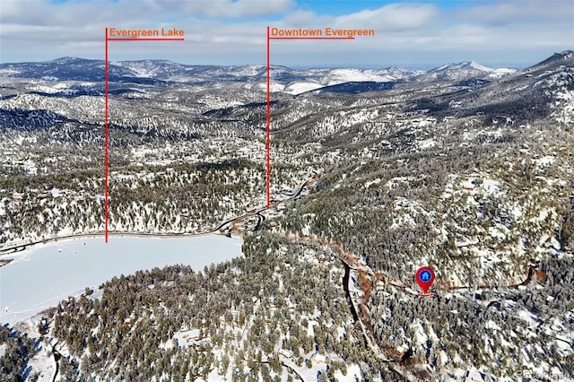 snowy aerial view featuring a mountain view